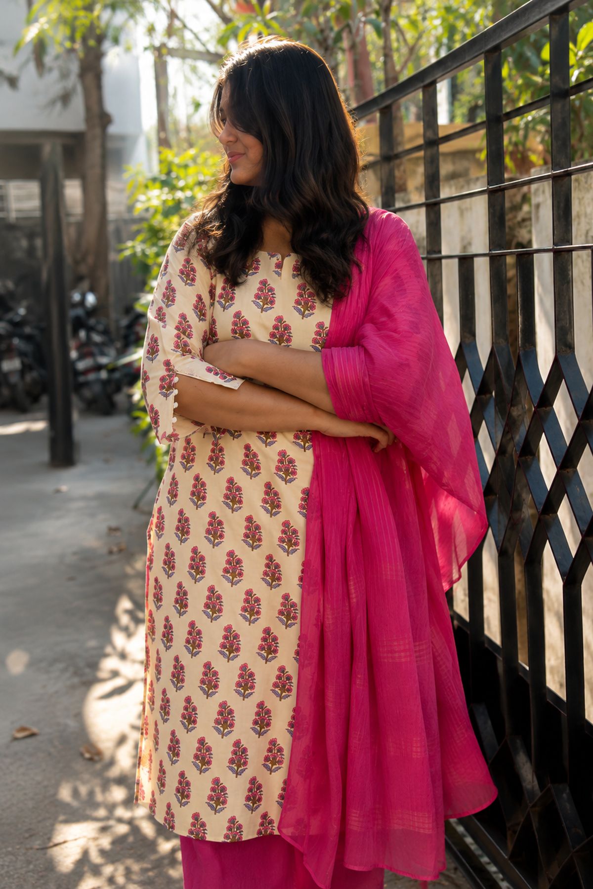 Butter yellow kurta with pink floral buti print, worn with a magenta dupatta and pants
