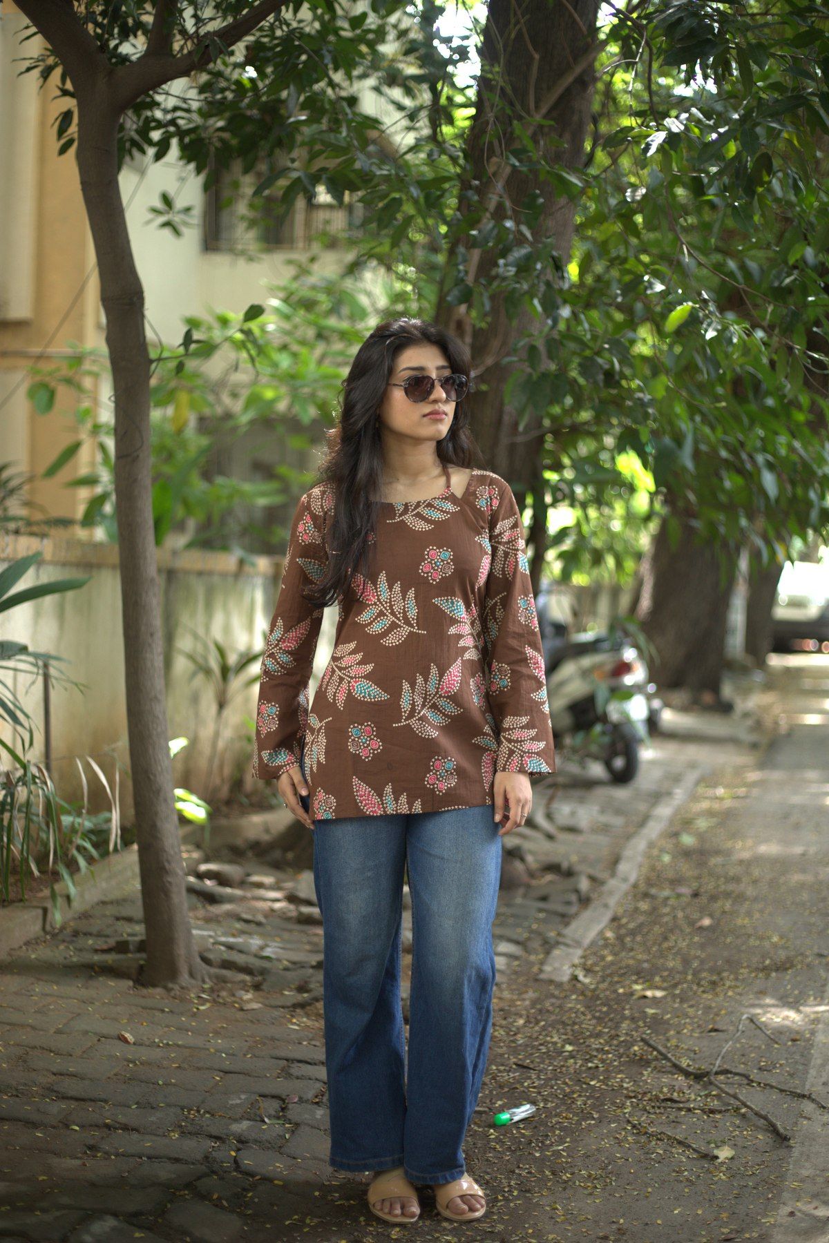 Front view of the cocoa sprig top worn with jeans
