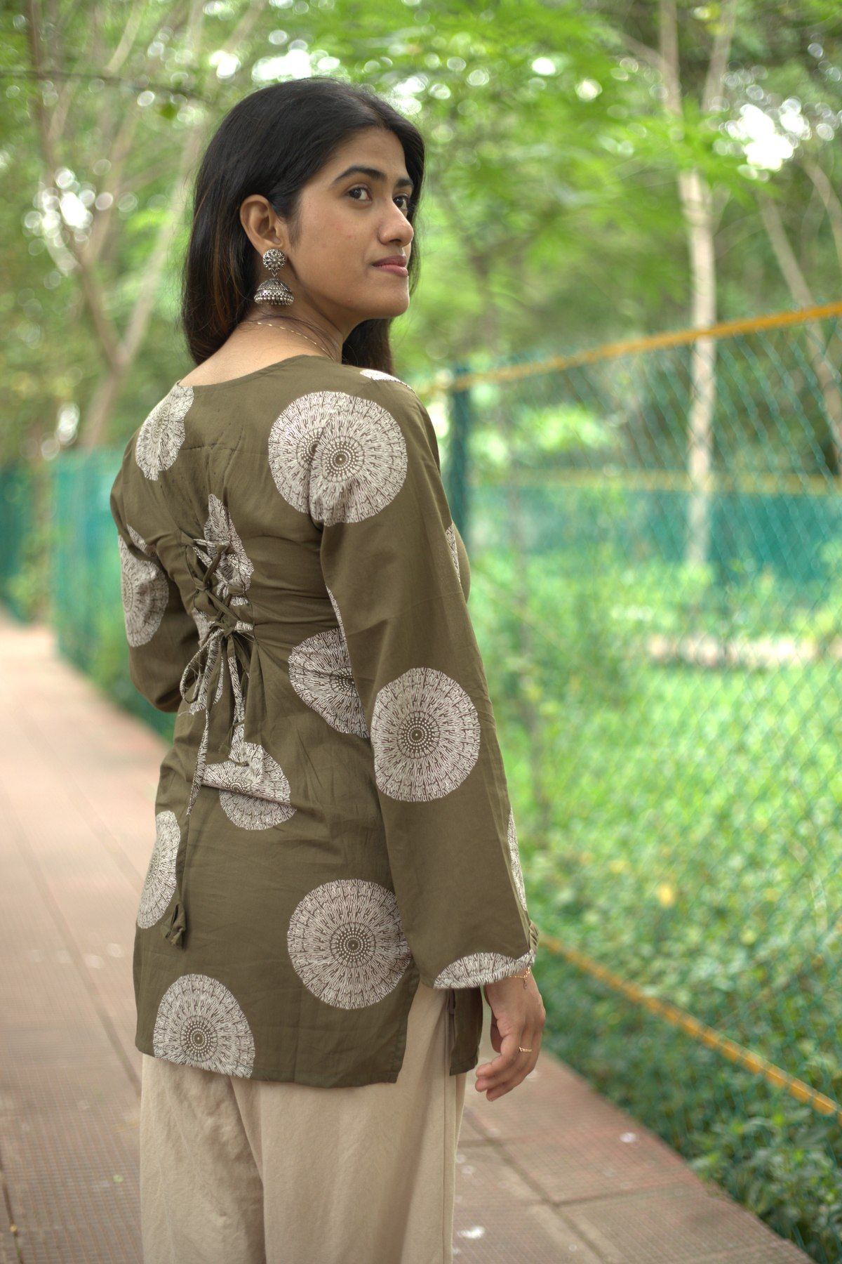 Back view showing the side lacing and the mandala print across the shoulders