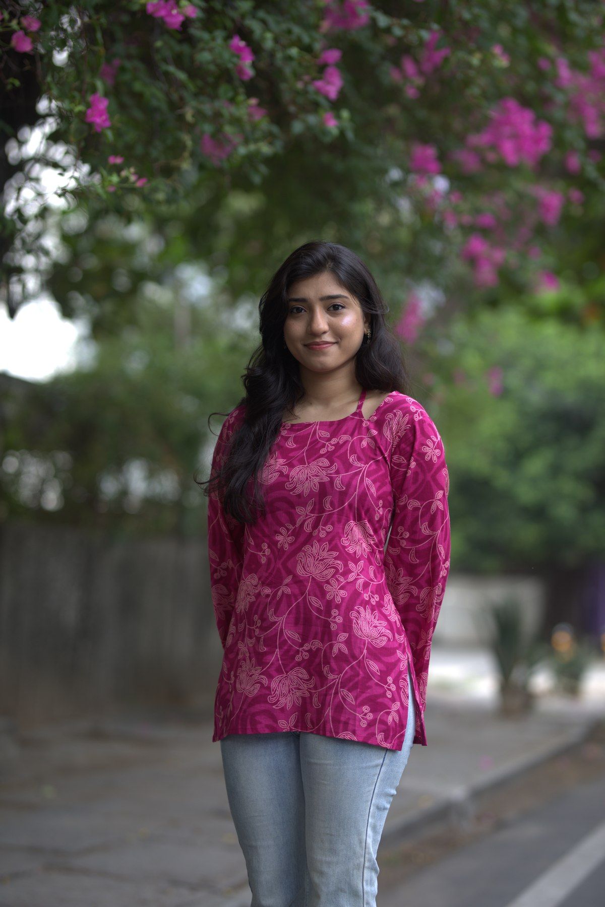 Front view of the plum lotus top worn with jeans
