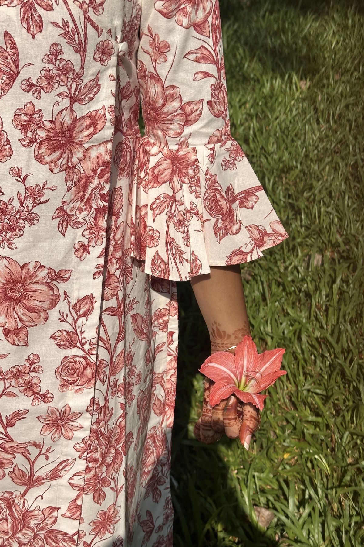 Close view of the pleated fluted cuff and the printed roses